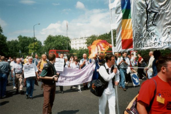 The start of the 1996 LBGT Pride march - the corner of the main banner can be seen, complete with the word "bisexual" and first in the march are people from the Gay Liberation Front