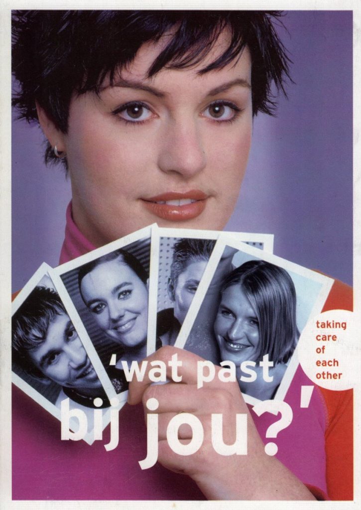 A postcard of a young woman holding up four b/w photos (of partners?) with the headline 'what suits you?'
